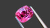 Bright cushion-cut 1.06 carat pink spinel gemstone set against a luxurious charcoal grey background. Ethically sourced from Mogok, Myanmar, perfect for bespoke fine jewellery.