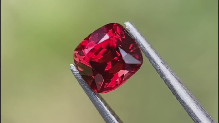 Red natural spinel gemstone with eye-clean clarity, cushion-cut, shown in natural light. Ideal for fine jewellery and appealing to international buyers.