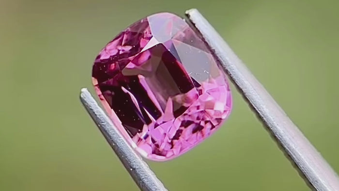 Vivid pink cushion-cut natural spinel gemstone, ethically sourced from Myanmar, captured in daylight. Perfect for custom fine jewellery and engagement rings.