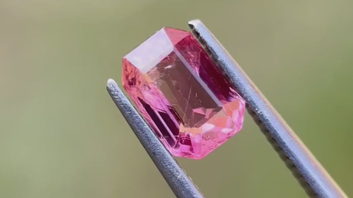 Vivid pink natural spinel with inclusions, showcasing its unique colour. Perfect for distinctive jewellery pieces.